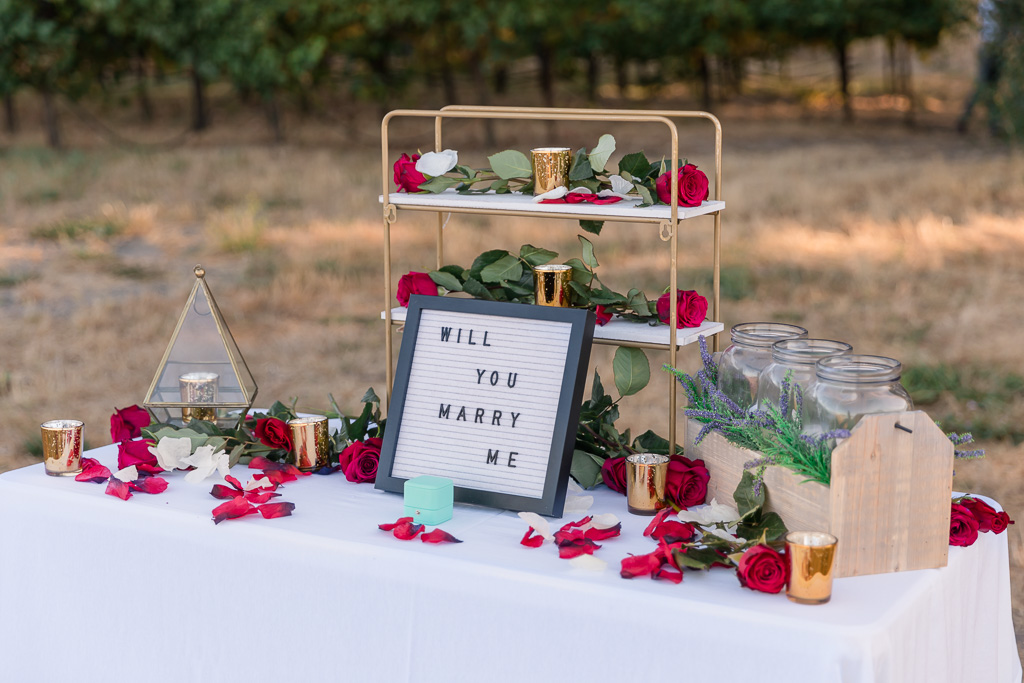 a sweet proposal table set up by the groom himself