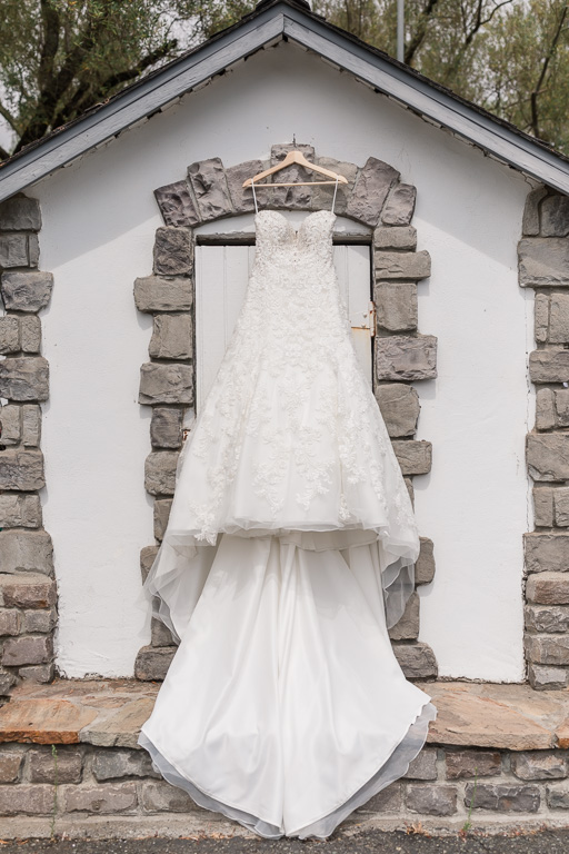 wedding gown hanging outdoors on a cute house