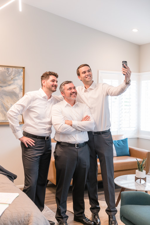 groomsmen taking a group selfie