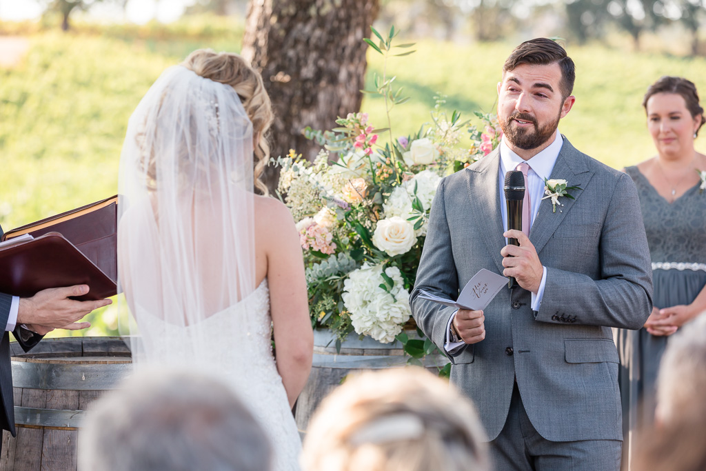 groom reads his vows at the ceremony