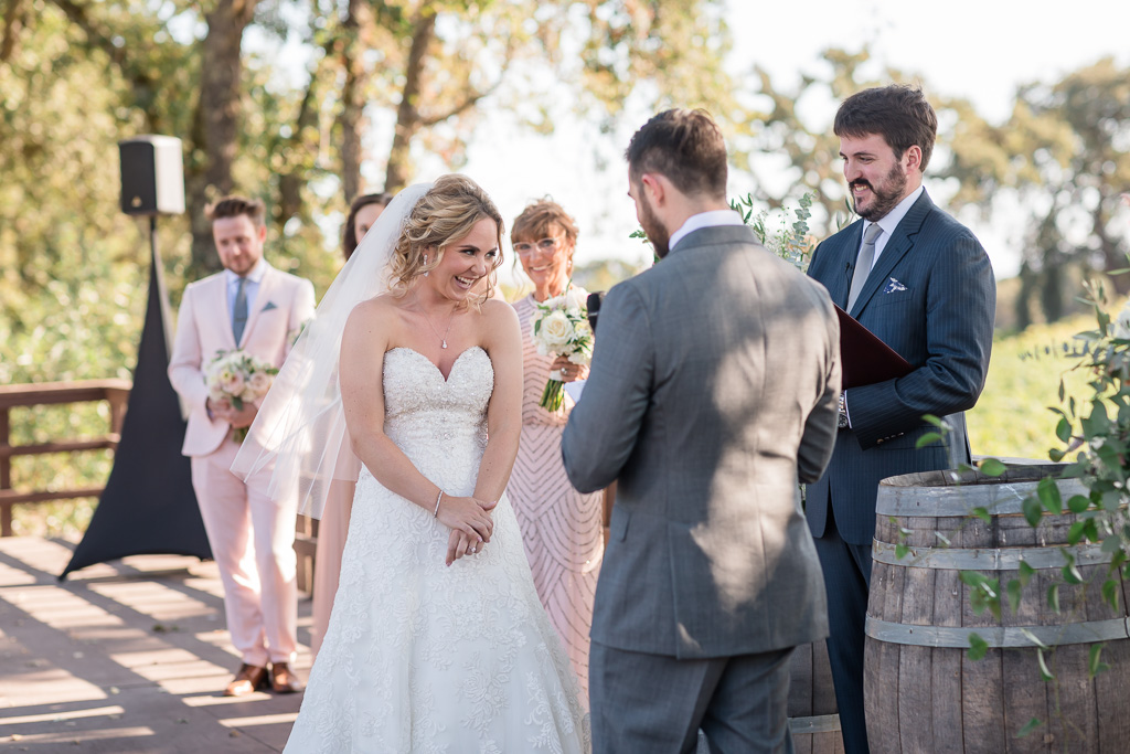 bride giggles at groom's sweet and funny vows