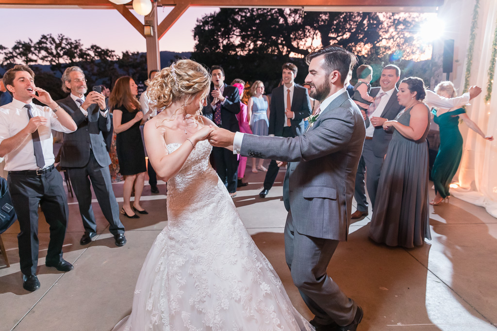 bride and groom dancing together at their reception dance party
