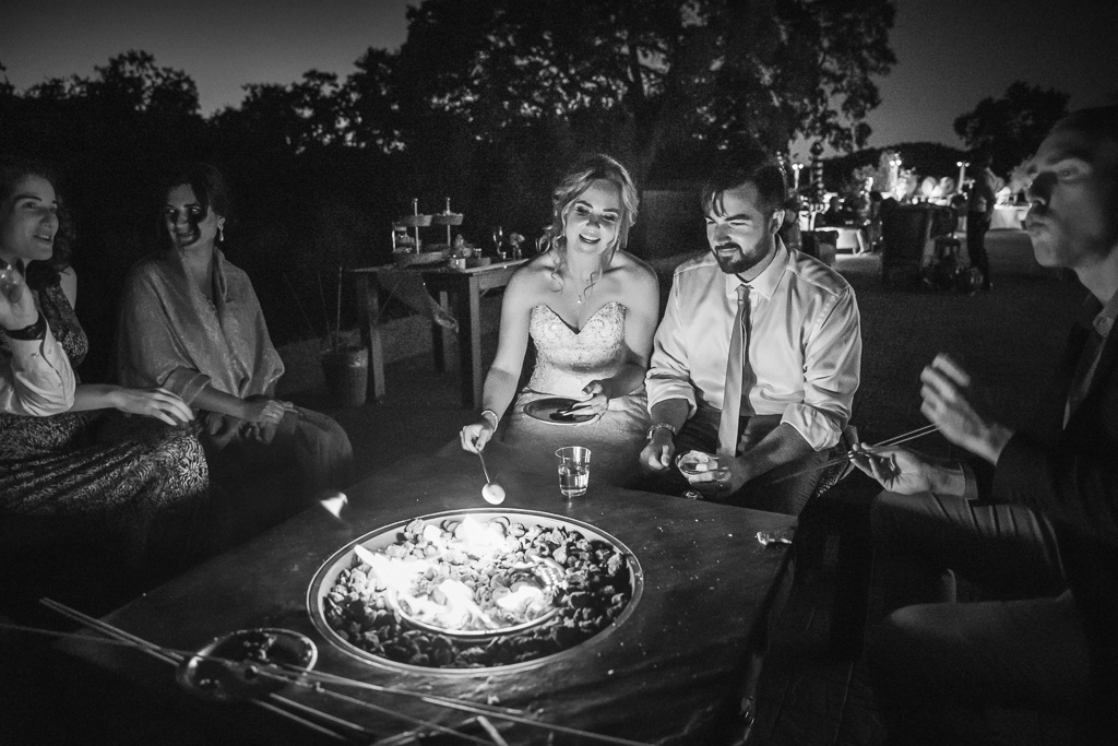 bride and groom at the s'mores fire pit with their wedding guests