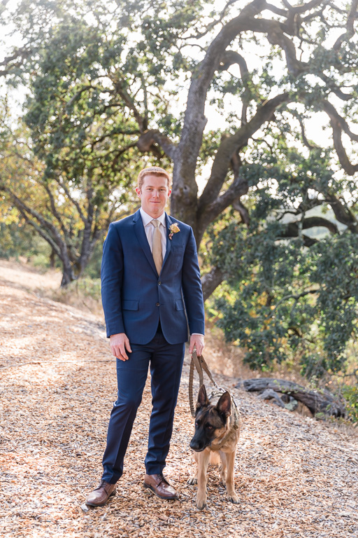groom and his dog ready for the first look