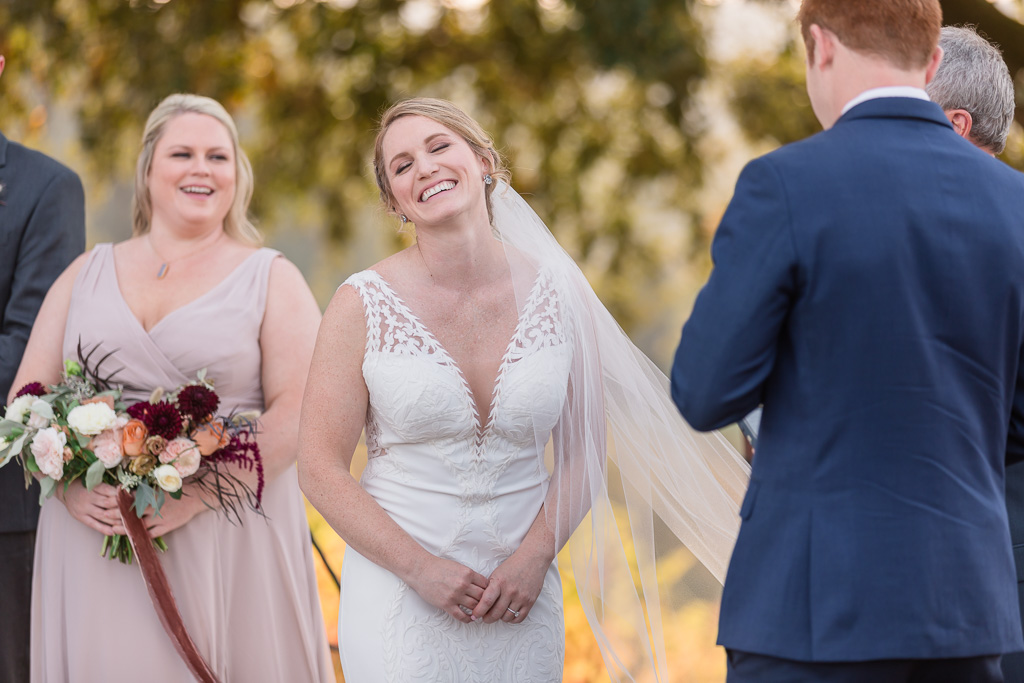 bride laughing to groom's funny vows