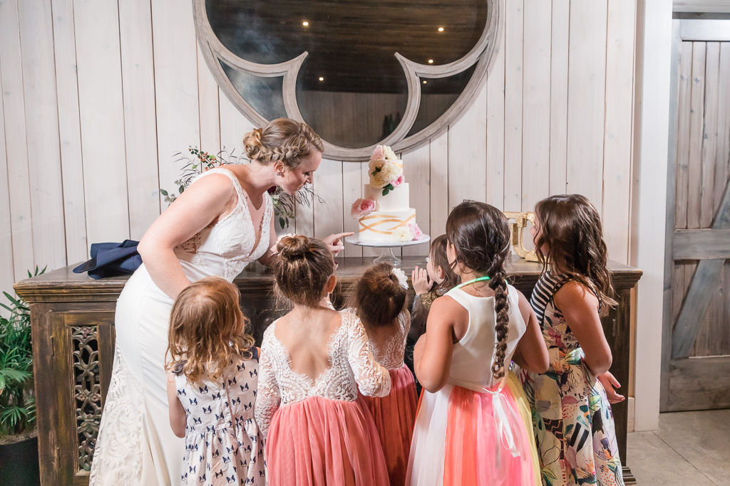 kids surround the cake table