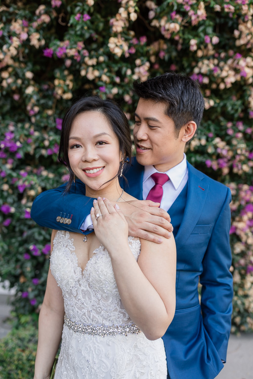 wedding portrait in front of the mansion's purple flower wall
