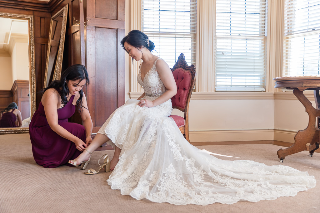 cute getting ready moment when bride putting on shoes