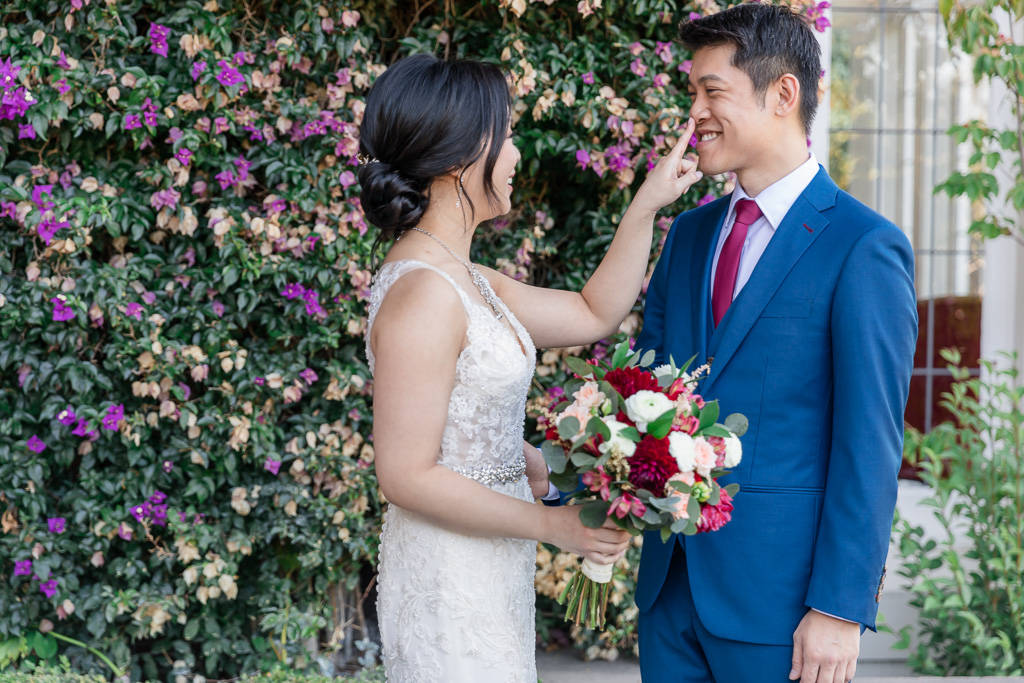 bride poking groom's nose after seeing each other