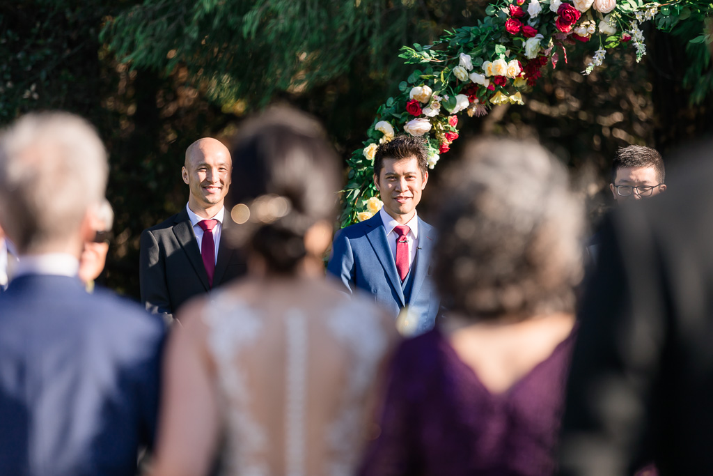 groom's reaction during bride's grand entrance at the ceremony