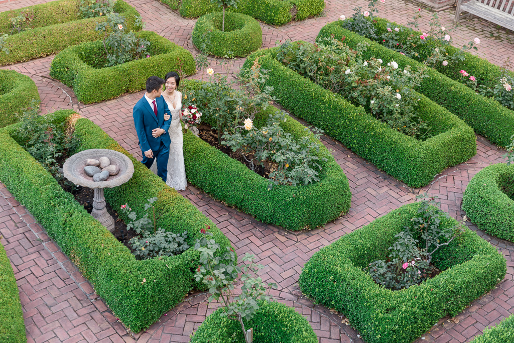 newlyweds walking in the beautifully landscaped garden