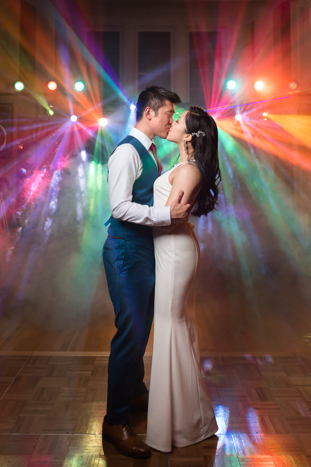 colorful unique DJ lights with fog machine night time wedding portrait
