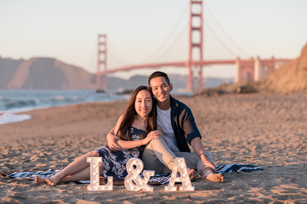 save-the-date picture on the sand in front of Golden Gate Bridge