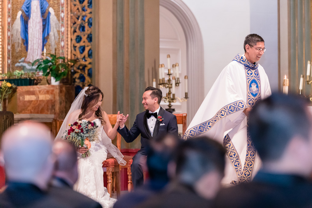 a sweet and happy moment between bride and groom during their church ceremony