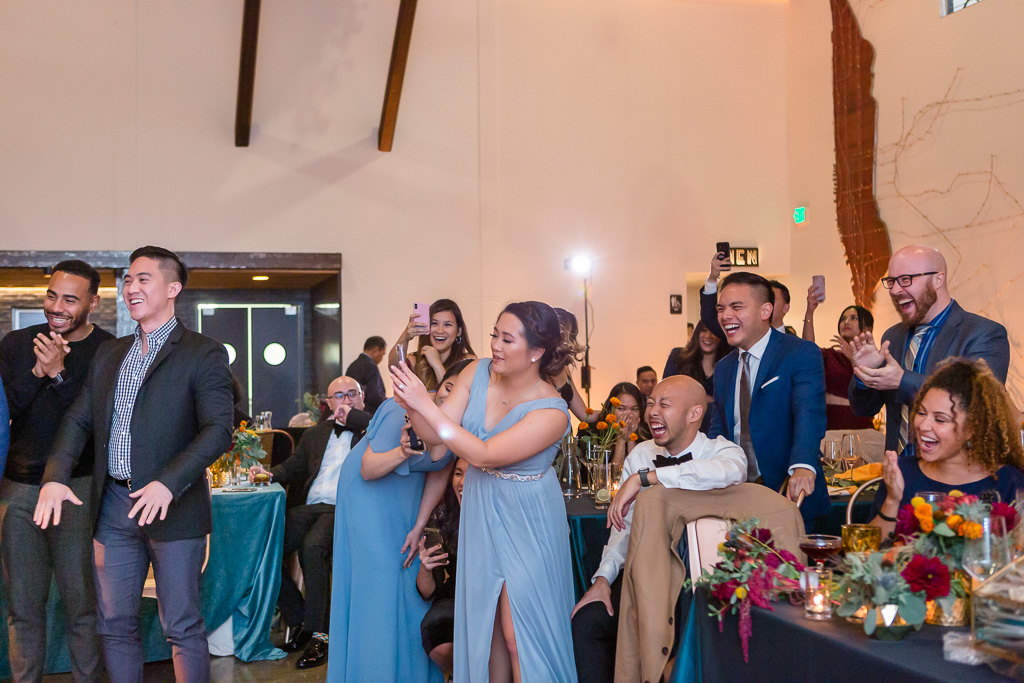 happy wedding guests taking video of the epic moment