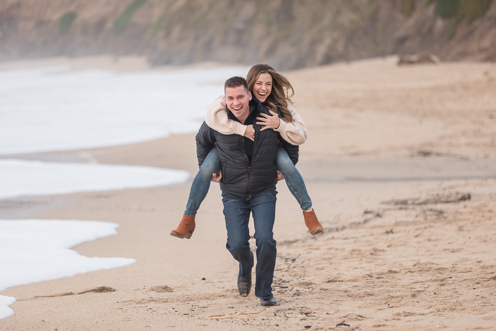 piggyback ride engagement photos on the beach