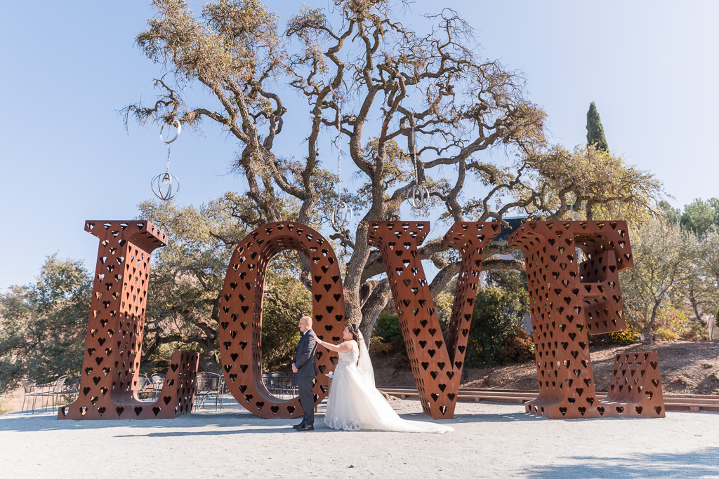 Willow Heights Mansion wedding first look by the love sign