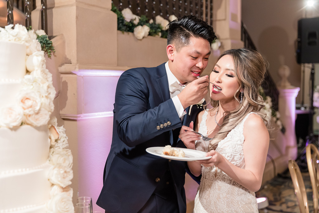 newlyweds feeding each other cake