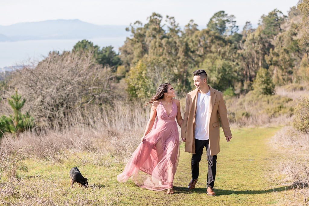 couple walking on the open trail in Berkeley for their save-the-date photo