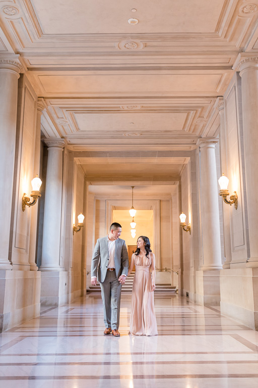 bride and groom walking on the SF city hall marble floor