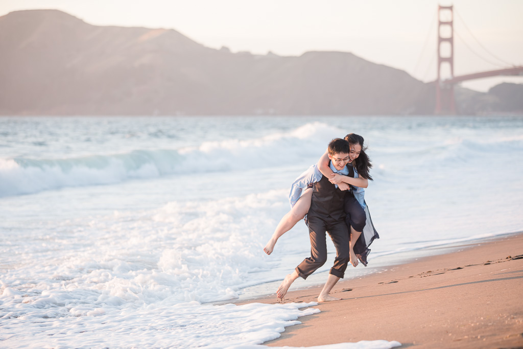 playful engagement session on the sand beach