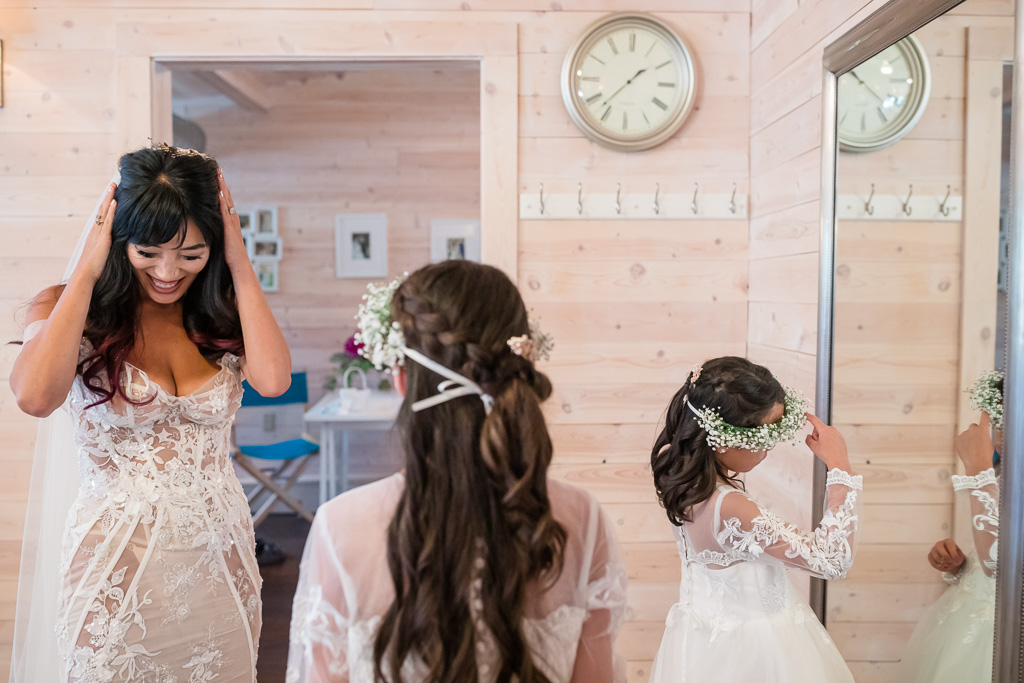 bride and two flower girls getting ready for ceremony
