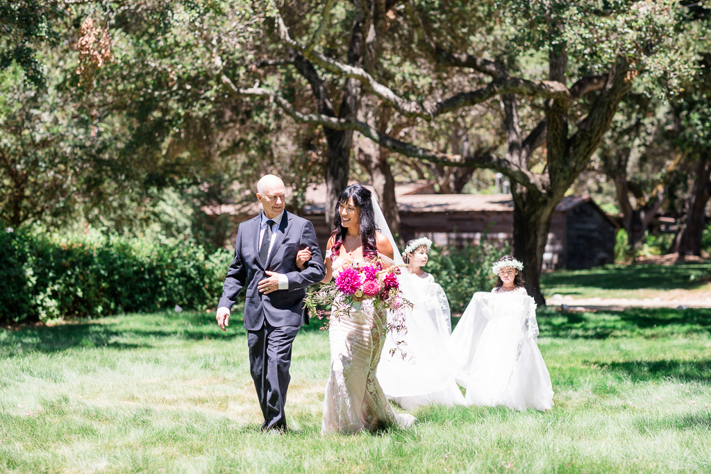 bride and her father walking out with her daughters the flower girls