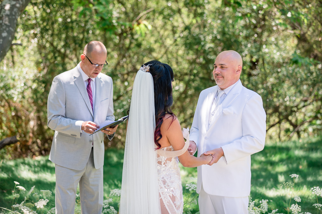 bride, groom, officiant during wedding ceremony