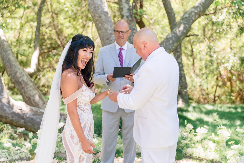 bride being surprised by a surprise wedding ring from her groom