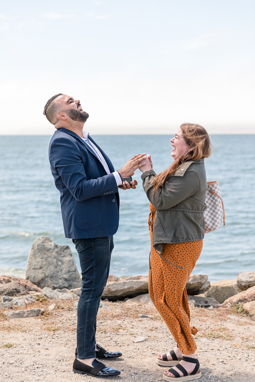 sweet laughing moment after their proposal by the Bay