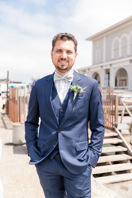 groom solo portrait by the water