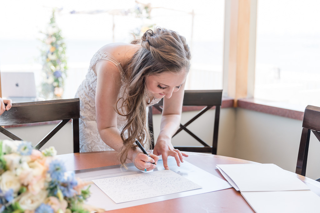 bride signing the ketubah