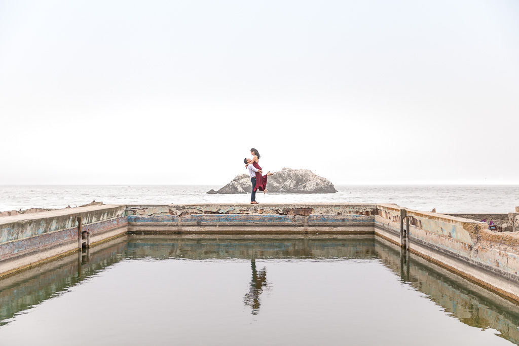Sutro Baths water reflection lift up engagement photo