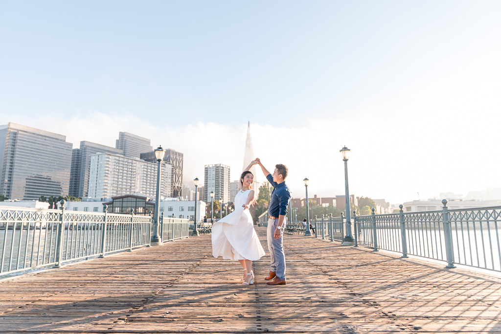 Pier 7 engagement photo with fog rolling in over San Francisco