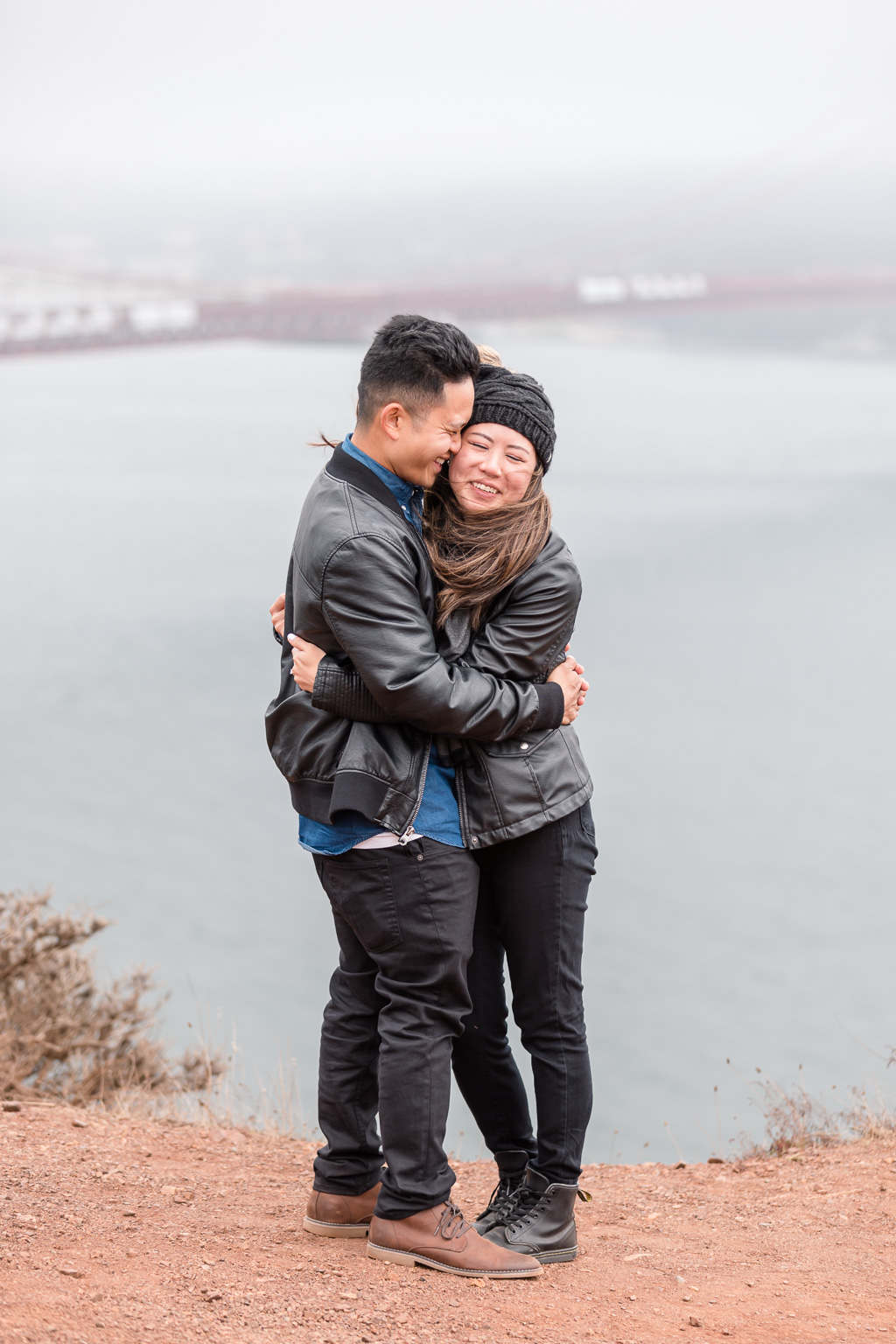 cute hugging and kissing photo in front of Golden Gate Bridge