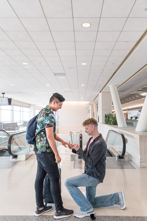 putting on the ring after he said yes at the airport