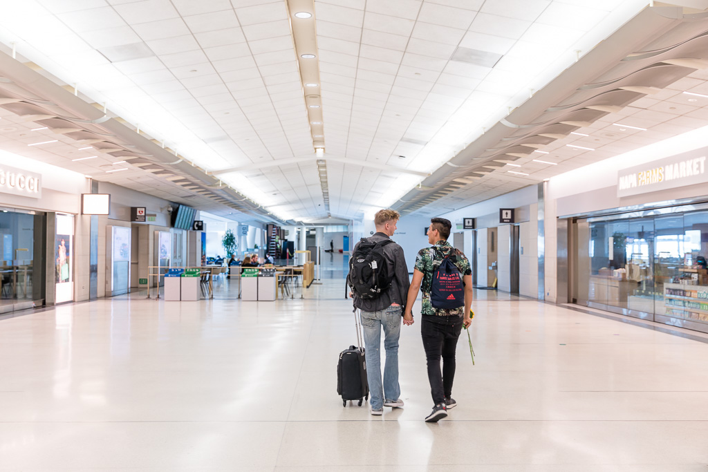 couple walking down hallway in empty airport