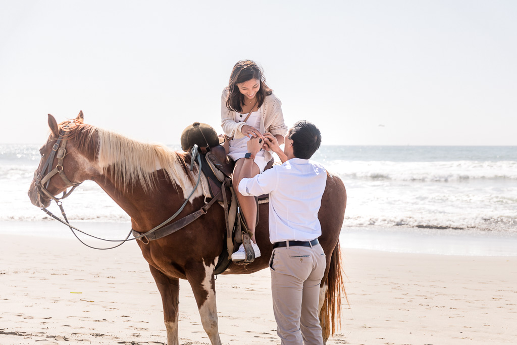 putting on the ring after horseback proposal