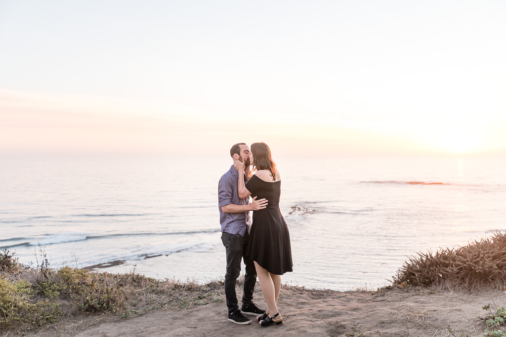 couple kissing on Half Moon Bay cliffside