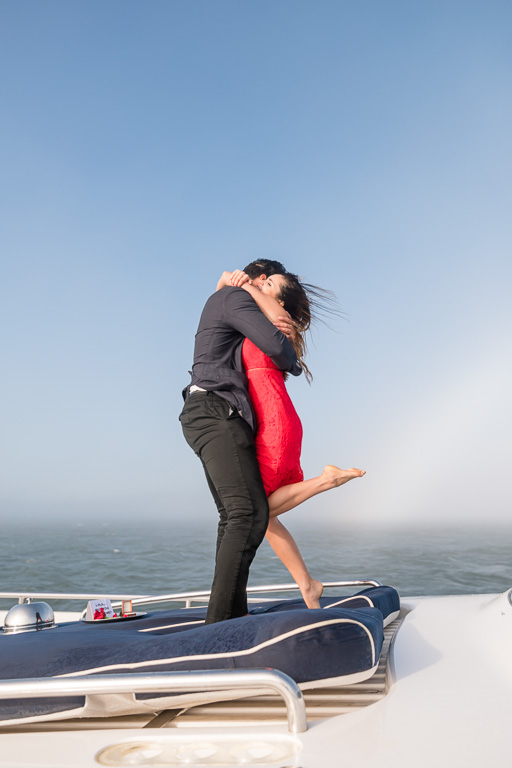 a hug on the bow of a yacht