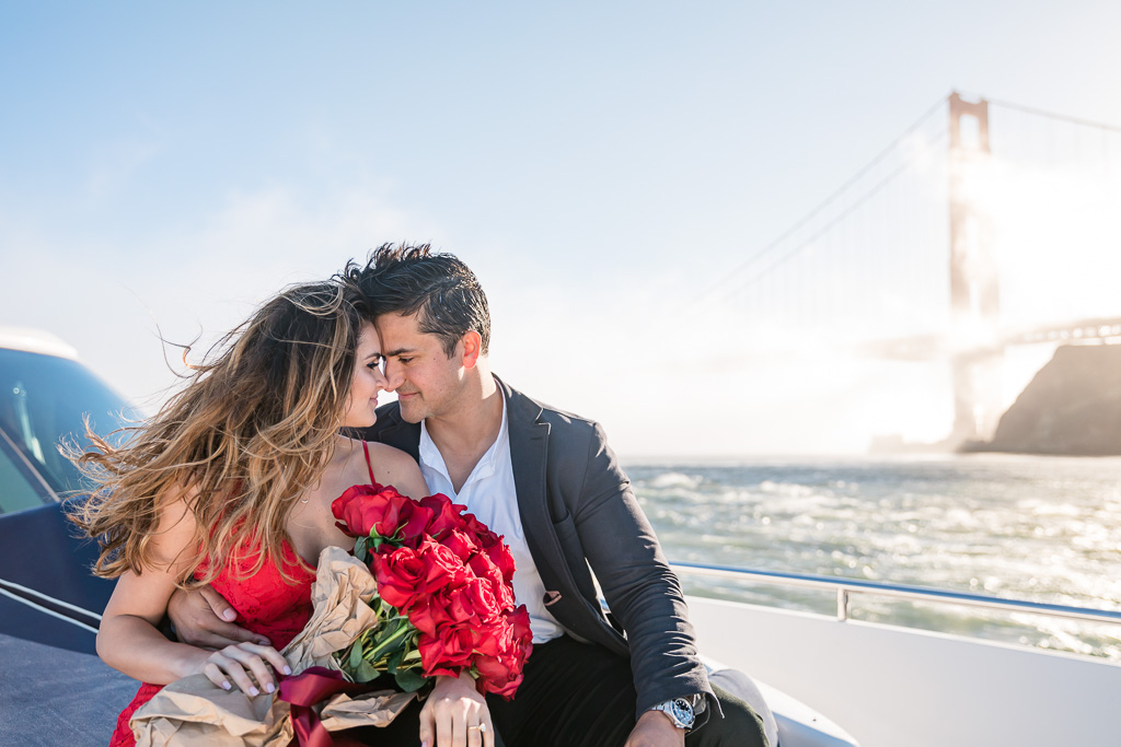 engagement photo on a boat in the San Francisco Bay with Golden Gate Bridge background
