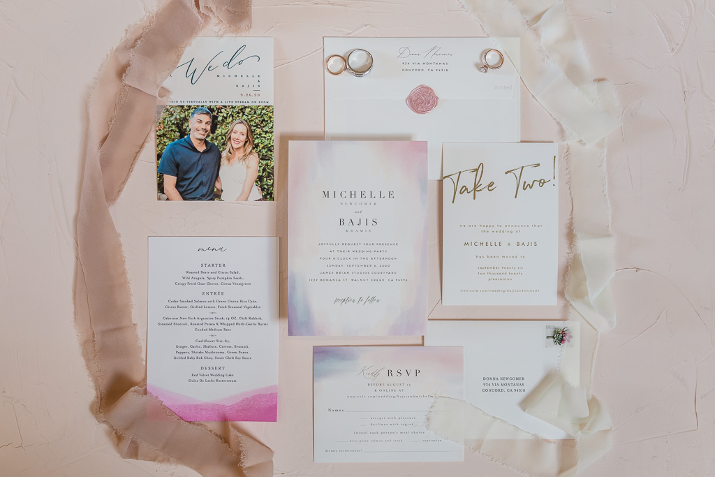 wedding details flat-lay with invitations and rings
