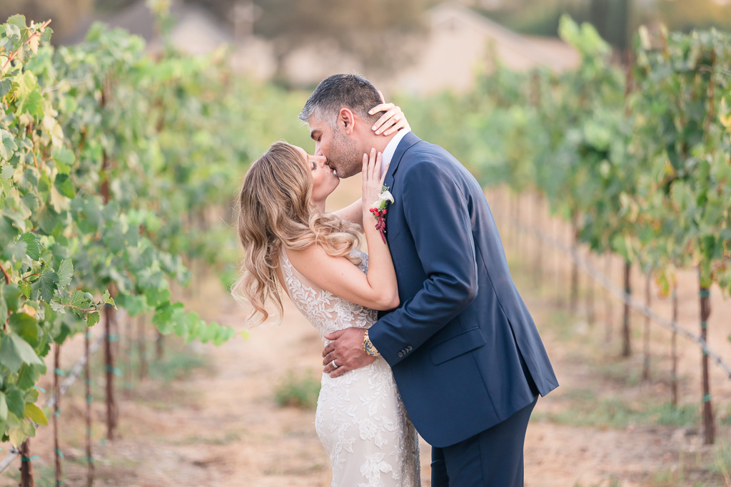 soft romantic kissing in vineyards