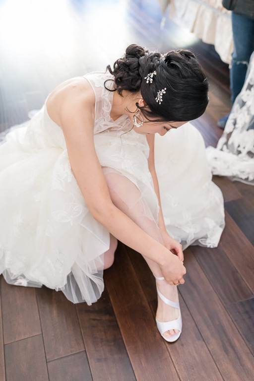 bride putting on her own shoes