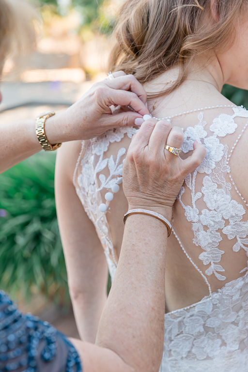 buttoning up back of bride's dress