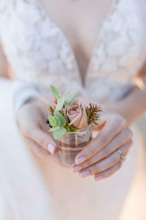 bride holding onto boutonniere
