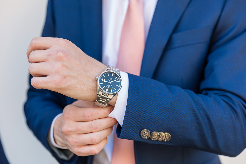 detail photo of groom's watch and hands