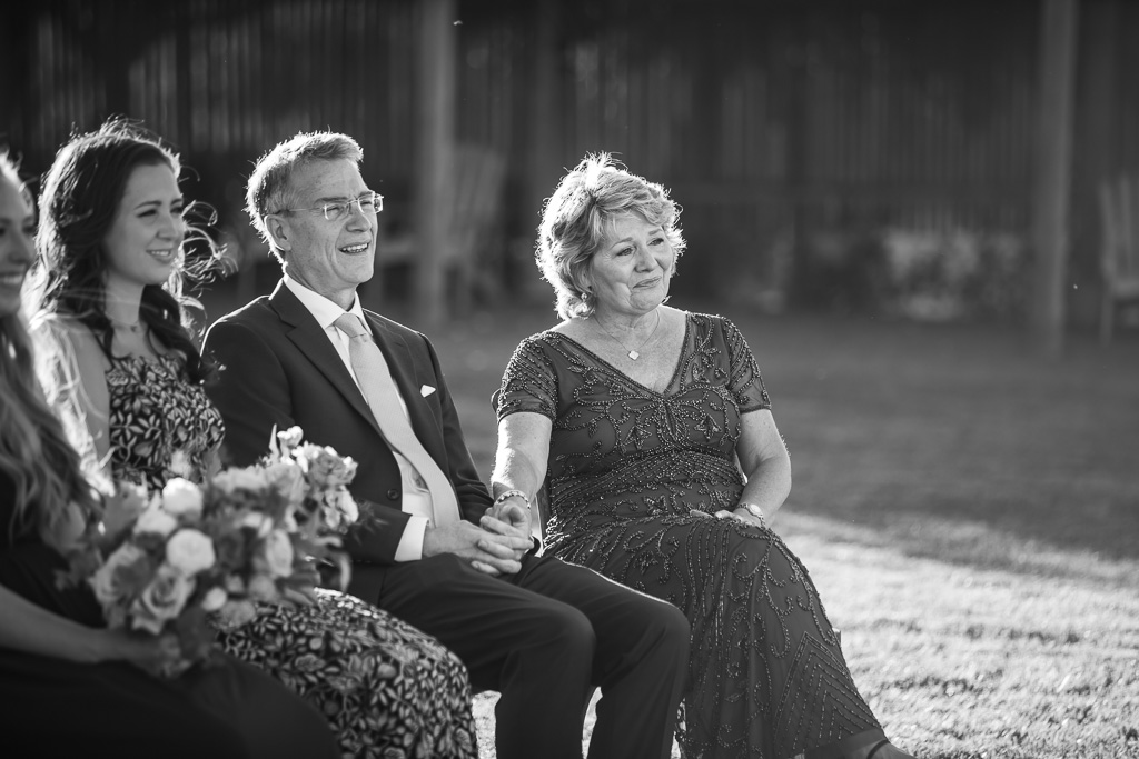 black and white photo of the bride's parents during ceremony