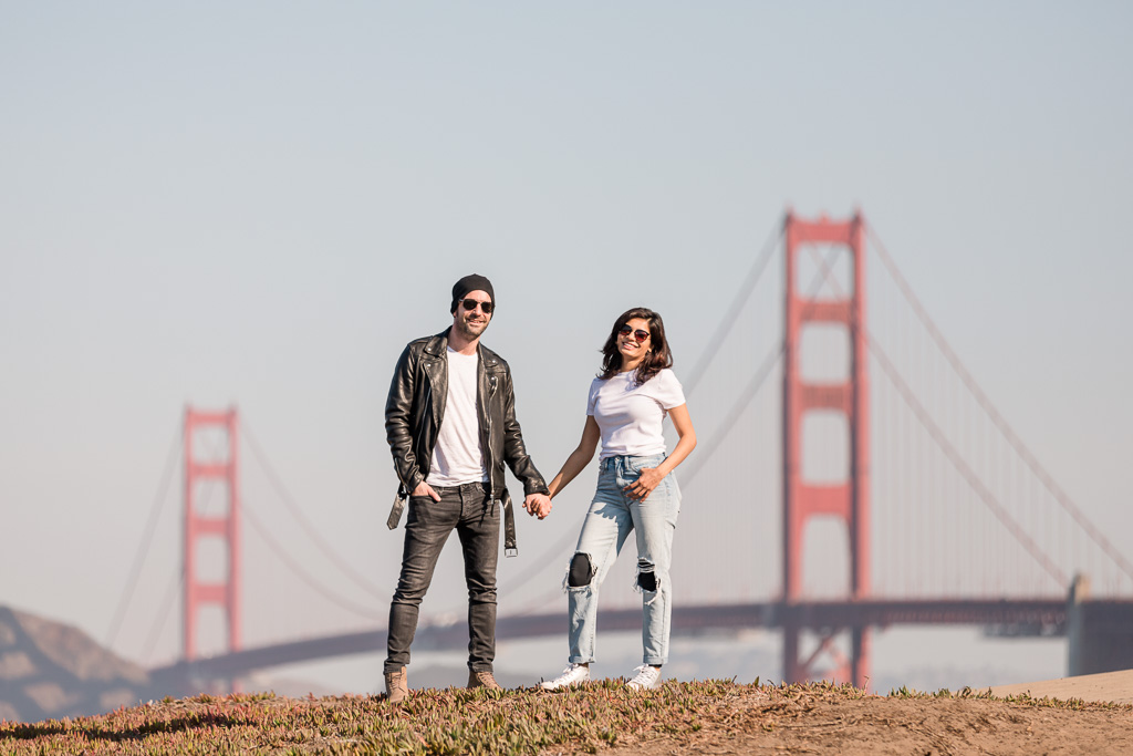 stylish travel couple portrait in front of Golden Gate Bridge