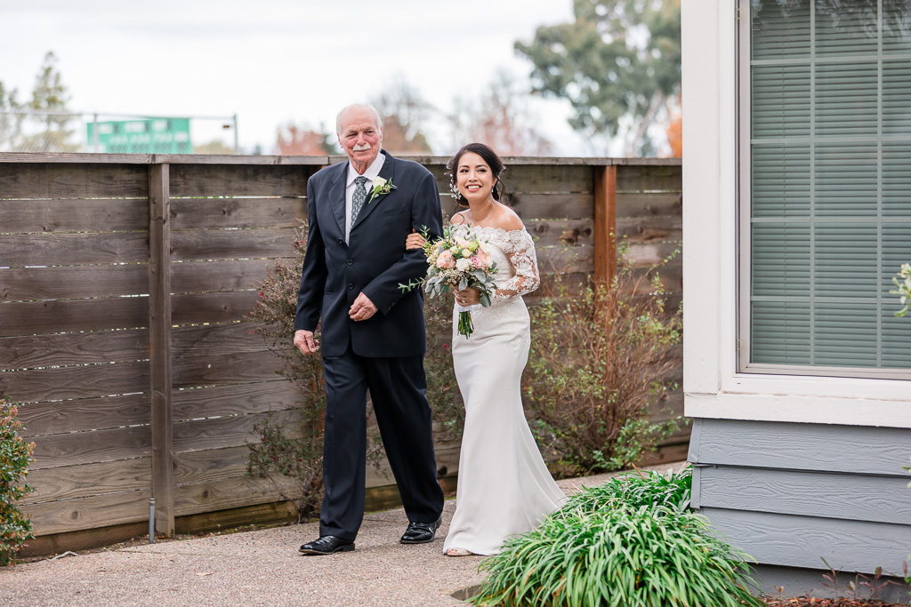 bride and father walking out for backyard wedding ceremony